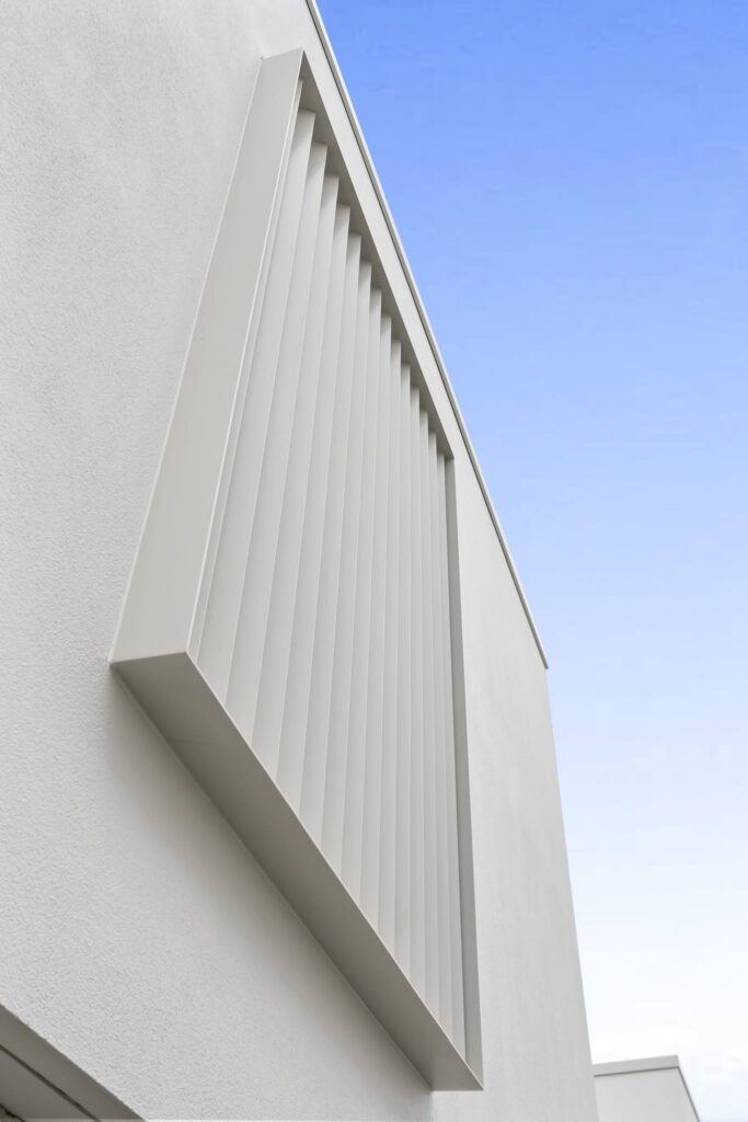 ashby_and_co_Gresford_Street_interior_exterior_7 Exterior detail of plastered wall and cladding panel showing precise rendering, plaster repair quality and durable plaster cladding finish.